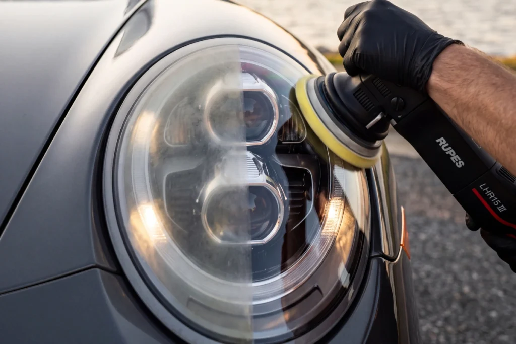 Technician buffing cloudy headlight lens